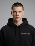 Close-up of the model wearing Signature Hoodie Unisex